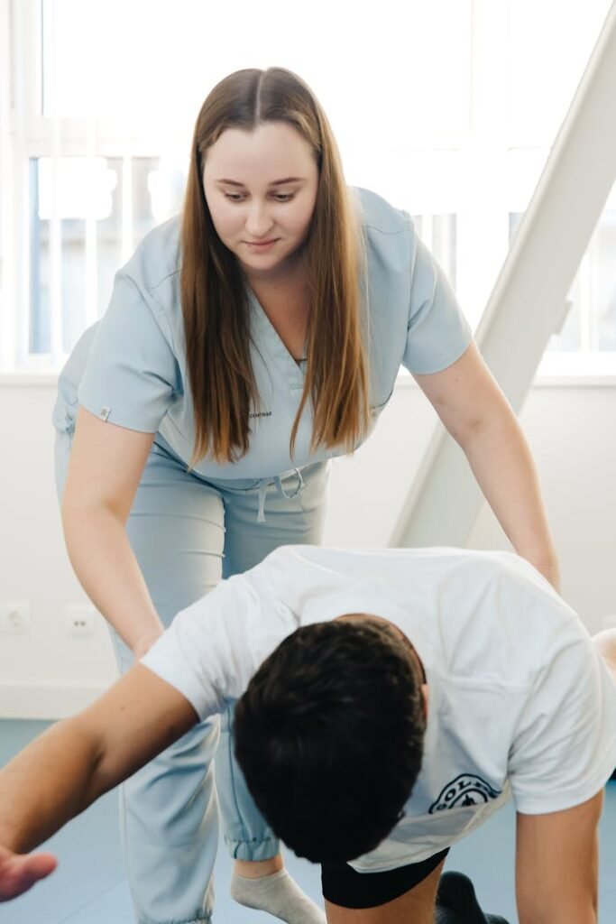 A woman doing a stretching exercise with a man