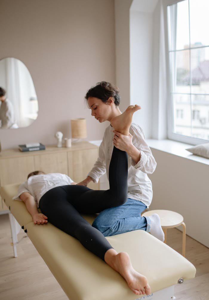 Physiotherapist Holding Patients Leg